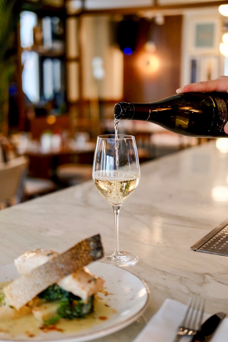 Photo by Pinar Kucuk person pouring liquid in clear wine glass
